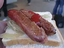 Sausages with onions in bread from a sausage sizzle