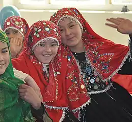 Hazara girls wearing red traditional clothes in Ghazni