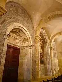 Lateral aisles supported by groin vaulting and walls decorated with 16th-century Mudéjar tiles.