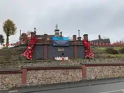 Memorial as described in body, with garlands of poppies on the retaining walls