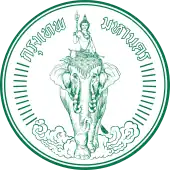 A round seal bearing the image of Indra riding Airavata among clouds, with the words "Krung Thep Maha Nakhon" (in Thai) across the top