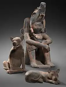 Sculptures of a seated warrior and two dogs, 400-800 CE