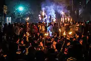 Protesters at night, with torches