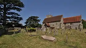 exterior of church and churchyard with residential building to the left