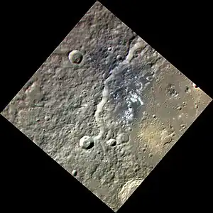 Approximate color image of western Sholem Aleichem crater, showing the hollows as white patches