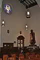 A view of the confessionals and statue of Mary and Jesus just to the side of the main altar