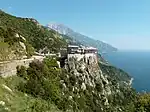 A large building complex and church built on a cliffside.