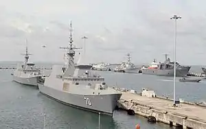 RSS Tenacious docked behind RSS Steadfast in Changi Naval Base during CARAT 2015.