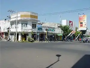 Street view in Singaraja, Bali, with a Djarum Super Compact Size advertisement in the far right, captured in 2005.