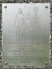 Image showing metal plaque depicting a nun with two children and words commemorating the first school patrol crossing in Saint Paul Minnesota on February 17 1921