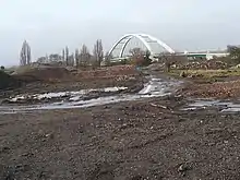 A cleared building site with the City Bridge in the background