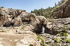 A small waterfall coming from a large mineral deposit