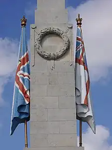 Carved flags either side of an obelisk