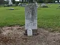 Confederate grave stone at cemetery with Southern Cross of Honor symbol displayed at top