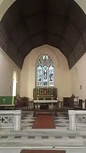 The altar, beneath stained glass windows