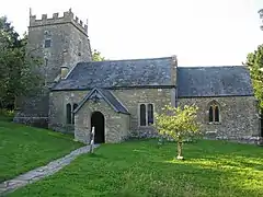 Stone building with square tower.