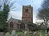 A stone Gothic church with a battlemented tower