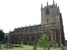 A Gothic stone church with a tower on the right