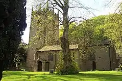 A stone Gothic church with a pinnacled tower