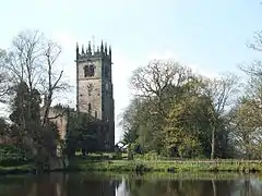 A Gothic stone church with a pinnacled tower