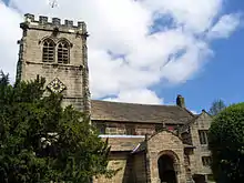 A stone church with a battlemented Gothic tower