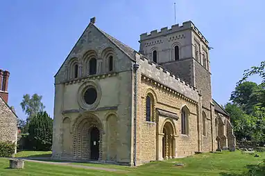 St Mary the Virgin, Iffley, 12th century, shows the detailed carving, particularly chevrons, and the side portal typical of Britain.