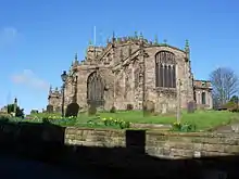 A broad stone Gothic church with its tower just visible at the far end