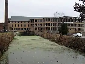 Stanely Woolen Mill, Nov. 11, 2009, founded by Moses Taft, in 1852 at Uxbridge, MA, with view of the Blackstone Canal; vertical integration of woolens to clothing was pioneered here