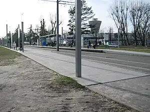 Double-track railway line in street with shelters on side platforms