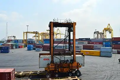 Straddle carriers moving shipping containers in Chittagong Port