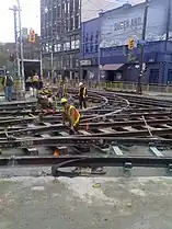 An intersection with the pavement removed, as workers repair the tracks for the Toronto streetcar system