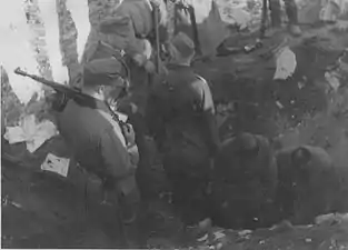 NARA copy #20, IPN copy #19A bunker being openedStroop witnesses digging out of a bunker, possibly near the ghetto wall. 8 May 1943