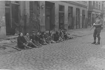 IPN copy #36They were also found in the underground bunkersCaptured Jews in front of Miła 31 and 33 viewed from Zamenhofa Street.