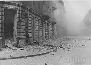 NARA copy #46, IPN copy #46(No image caption, in section This is how the former Ghetto looks after having been destroyed)Ulica Kupiecka Street viewed from Zamenhofa, with Zamenhofa 42 / Kupiecka 18 on the left.