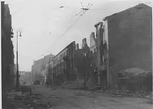 NARA copy #52, IPN copy #52(No image caption, in section This is how the former Ghetto looks after having been destroyed)Nalewki Street, viewed from Gęsia Street looking North, with Nalewki 31/Gęsia 2 on the left