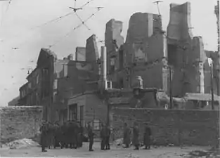 IPN copy #53(No image caption, in section This is how the former Ghetto looks after having been destroyed)Nalewki Street, looking South at the gate at Nalewki/Gęsia/Franciszkańska intersection. Beyond the wall on the right Posner house at Nalewkach 29.