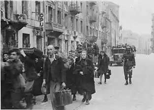 NARA copy #31To the transhipping placeColumn heading North to Umschlagplatz on Zamenhofa Street near Kupiecka. In the back buildings of Zamenhofa 30-40 block.