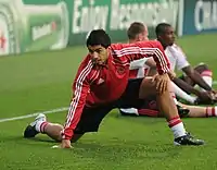 Football player Luis Suárez stretching prior to a match.