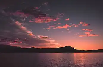 Sunrise in southeast Alaska. Sunsets and sunrises are sometimes pink because of an optical effect called Rayleigh scattering.