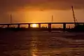 Sunset over the Cape Fear River flowing under the S. Thomas Rhodes Bridge.