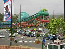 A view across Dreamworld and WhiteWater World's car park towards the Super Tubes Hydrocoaster and The Green Room