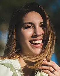 A woman with light brown hair smiling into the camera