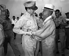 General Douglas MacArthur and Syngman Rhee, Korea's first President, warmly greet one another upon the General's arrival at Kimpo Air Force Base alt text