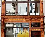 The T Gibson building in Long street, Cape Town is a two-storey building with a unique terracotta hard burnt clay finish. Designed by architect Anthony M de Witt, this building was originally occupied by Sellers Gents Outfitters, and later it became an art gallery. Current use: Commercial.