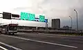 The main Taipei Bridge automobile bridge approaching Sanchong (三重) just before the exit ramp for Huánhé Road (環河北路) in 2008The bridge in the background above Taipei Bridge is the Huánhé Expressway (環河快速道路)