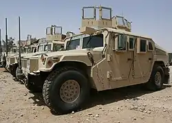 A group of Humvees lined up in a row.