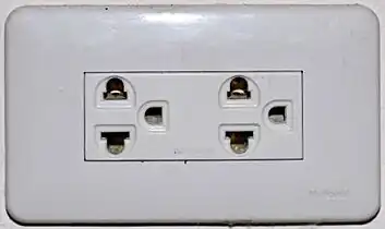 An earthed Thai socket that appears to comply with figure 4 of TIS 166-2549. Although it may accept NEMA plugs, the Thai voltage is 220 V and thus is electrically incompatible with devices designed only for 110 V.