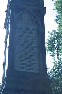 Inscription and bust of St Giles