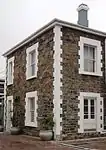 THE MOORINGS No. 1
Dwelling
inspected: September 1982

Double-storey, SW corner unit contains fabric of original Breakwater Convict Station. Plastered bluestone (shown unplastered in c1890 photograph), pitched corrugated iron roof. Type of site: House.