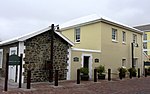 THE MOORINGS No. 2 AND No. 3
Dwellings
inspected: September 1982

Double-storey, 3-bay, SW façade:
Ground: plastered stoep wall and piers, steel roof sheeting. Centrally divided glazed and lower flush panelled teak door, fanlight, ovolo moulded frame.